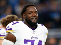 DETROIT,MICHIGAN-JANUARY 5:  Offensive tackle Cam Robinson (74) of the Minnesota Vikings j walks on the field ahead of a game between the De...