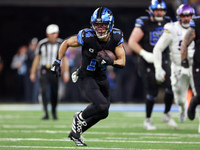 DETROIT,MICHIGAN-JANUARY 5:  Wide receiver Amon-Ra St. Brown (14) of the Detroit Lions carries the ball during a game between the Detroit Li...