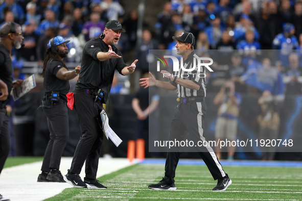 DETROIT,MICHIGAN-JANUARY 5:  Head coach Dan Campbell of the Detroit Lions interacts with down judge Kent Payne (79) during a game between th...