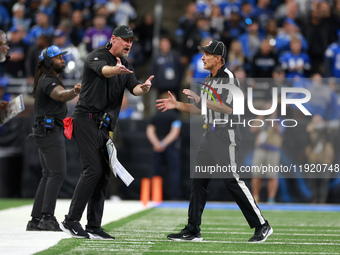 DETROIT,MICHIGAN-JANUARY 5:  Head coach Dan Campbell of the Detroit Lions interacts with down judge Kent Payne (79) during a game between th...