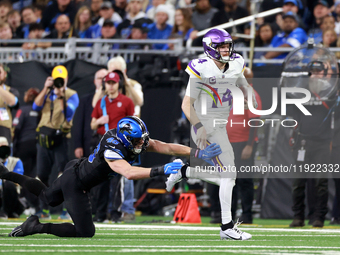 DETROIT,MICHIGAN-JANUARY 5:  Quarterback Sam Darnold (14) of the Minnesota Vikings runs the ball during a game between the Detroit Lions and...