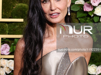 Demi Moore wearing a Giorgio Armani Prive gown and Christian Louboutin shoes arrives at the 82nd Annual Golden Globe Awards held at The Beve...