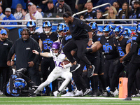 DETROIT,MICHIGAN-JANUARY 5:  Quarterback Sam Darnold (14) of the Minnesota Vikings runs the ball as Detroit Lions staff leaps to avoid a col...