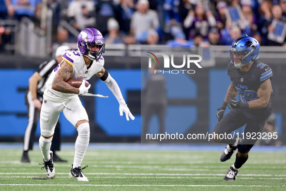 DETROIT,MICHIGAN-JANUARY 5:  Wide receiver Jalen Nailor (83) of the Minnesota Vikings runs the ball under the pressure of safety Brian Branc...