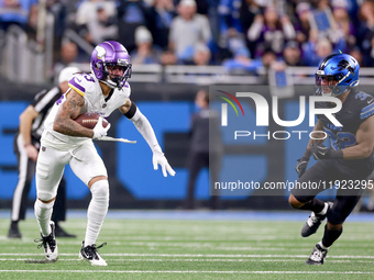 DETROIT,MICHIGAN-JANUARY 5:  Wide receiver Jalen Nailor (83) of the Minnesota Vikings runs the ball under the pressure of safety Brian Branc...