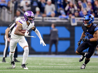 DETROIT,MICHIGAN-JANUARY 5:  Wide receiver Jalen Nailor (83) of the Minnesota Vikings runs the ball under the pressure of safety Brian Branc...