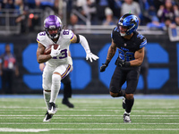 DETROIT,MICHIGAN-JANUARY 5:  Wide receiver Jalen Nailor (83) of the Minnesota Vikings runs the ball under the pressure of safety Brian Branc...