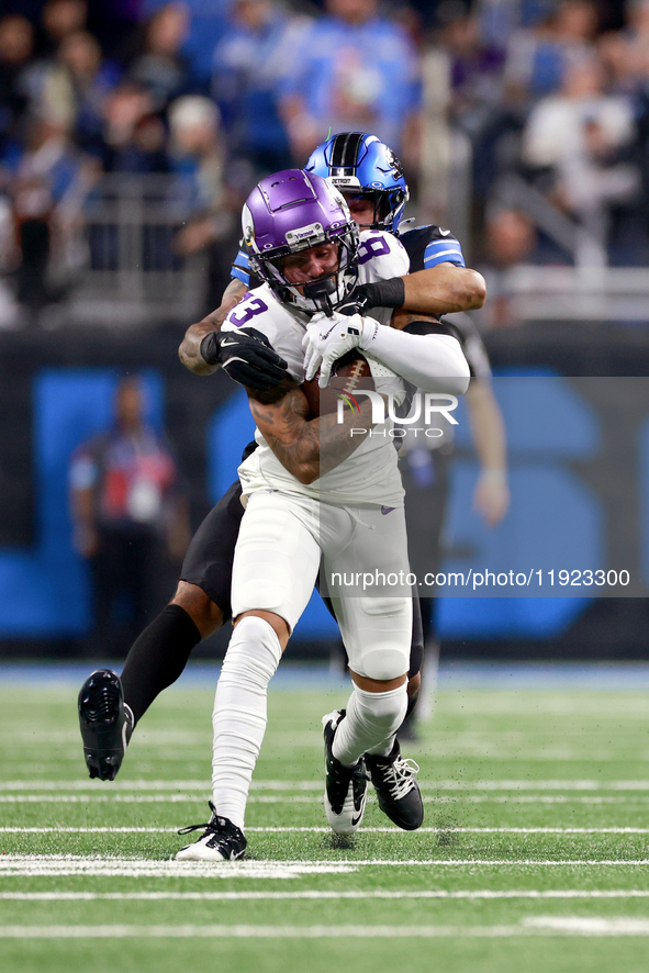 DETROIT,MICHIGAN-JANUARY 5:  Wide receiver Jalen Nailor (83) of the Minnesota Vikings runs the ball under the pressure of safety Brian Branc...