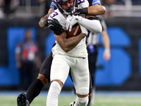 DETROIT,MICHIGAN-JANUARY 5:  Wide receiver Jalen Nailor (83) of the Minnesota Vikings runs the ball under the pressure of safety Brian Branc...