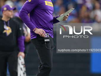 DETROIT,MICHIGAN-JANUARY 5:  Minnesota Vikings head coach Kevin O'Connell walks on the sidelines during a game between the Detroit Lions and...