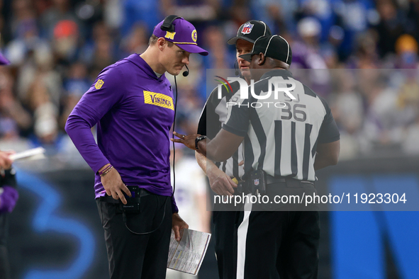 DETROIT,MICHIGAN-JANUARY 5:  Minnesota Vikings head coach Kevin O'Connell talks with officials on the sidelines during a game between the De...