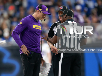 DETROIT,MICHIGAN-JANUARY 5:  Minnesota Vikings head coach Kevin O'Connell talks with officials on the sidelines during a game between the De...