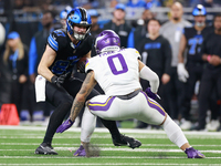 DETROIT,MICHIGAN-JANUARY 5:  Tight end Sam LaPorta (87) of the Detroit Lions carries the ball under the pressure of linebacker Ivan Pace Jr....