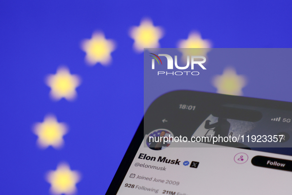 European Union flag displayed on a laptop screen and Elon Musk account on X displayed on a phone screen are seen in this illustration photo...