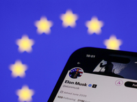 European Union flag displayed on a laptop screen and Elon Musk account on X displayed on a phone screen are seen in this illustration photo...