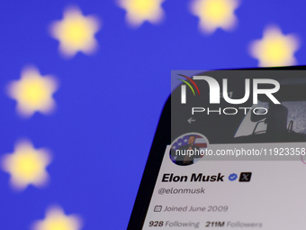 European Union flag displayed on a laptop screen and Elon Musk account on X displayed on a phone screen are seen in this illustration photo...