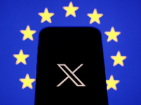 European Union flag displayed on a laptop screen and X logo displayed on a phone screen are seen in this illustration photo taken in Krakow,...