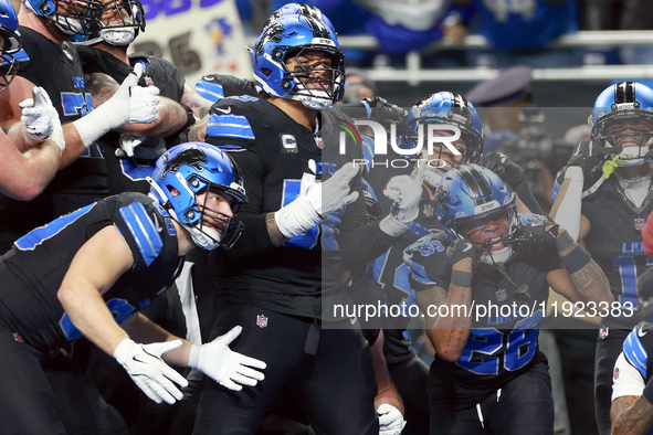 DETROIT,MICHIGAN-JANUARY 5:  Detroit Lions teammates celebrate a touchdown with running back Jahmyr Gibbs (26) of the Detroit Lions during a...