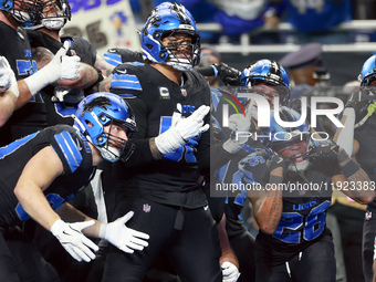 DETROIT,MICHIGAN-JANUARY 5:  Detroit Lions teammates celebrate a touchdown with running back Jahmyr Gibbs (26) of the Detroit Lions during a...