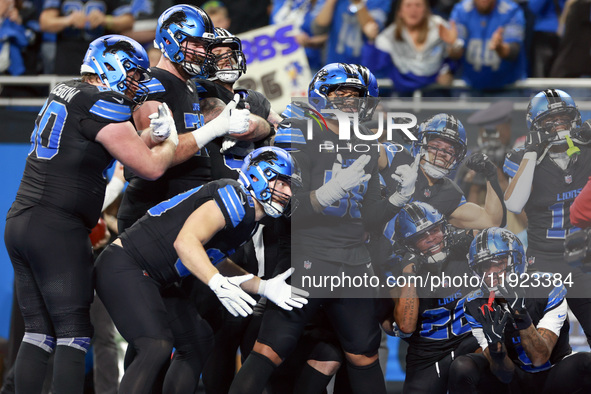 DETROIT,MICHIGAN-JANUARY 5:  Detroit Lions teammates celebrate a touchdown with running back Jahmyr Gibbs (26) of the Detroit Lions during a...