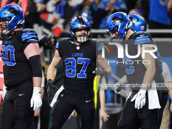 DETROIT,MICHIGAN-JANUARY 5:  Tight end Sam LaPorta (87) of the Detroit Lions reacgts to a touchdown during a game between the Detroit Lions...