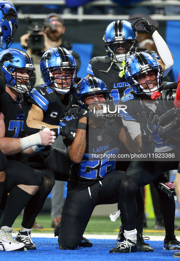 DETROIT,MICHIGAN-JANUARY 5:  Detroit Lions teammates celebrate a touchdown with running back Jahmyr Gibbs (26) of the Detroit Lions during a...