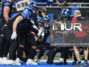 DETROIT,MICHIGAN-JANUARY 5:  Detroit Lions teammates celebrate a touchdown with running back Jahmyr Gibbs (26) of the Detroit Lions during a...