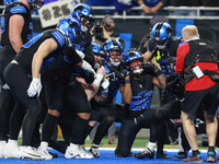 DETROIT,MICHIGAN-JANUARY 5:  Detroit Lions teammates celebrate a touchdown with running back Jahmyr Gibbs (26) of the Detroit Lions during a...