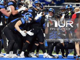 DETROIT,MICHIGAN-JANUARY 5:  Detroit Lions teammates celebrate a touchdown with running back Jahmyr Gibbs (26) of the Detroit Lions during a...