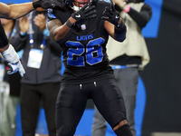 DETROIT,MICHIGAN-JANUARY 5:  Running back Jahmyr Gibbs (26) of the Detroit Lions celebrates a touchdown during a game between the Detroit Li...