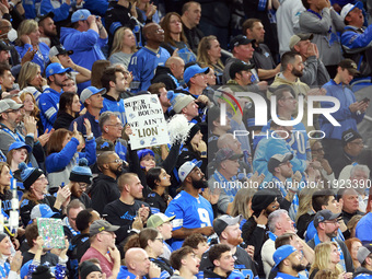 DETROIT,MICHIGAN-JANUARY 5:  Fans follow the paly  during a game between the Detroit Lions and the Minnesota Vikings in Detroit, Michigan US...