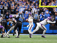 DETROIT,MICHIGAN-JANUARY 5:  Quarterback Sam Darnold (14) of the Minnesota Vikings looks for an opening during a game between the Detroit Li...