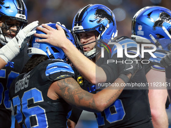 DETROIT,MICHIGAN-JANUARY 5:  Quarterback Jared Goff (16) of the Detroit Lions celebrates wih running back Jahmyr Gibbs (26) of the Detroit L...