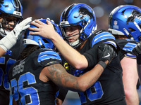 DETROIT,MICHIGAN-JANUARY 5:  Quarterback Jared Goff (16) of the Detroit Lions celebrates wih running back Jahmyr Gibbs (26) of the Detroit L...