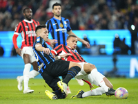 Malick Thiaw centre-back of AC Milan and Germany and Lautaro Martinez centre-forward of Internazionale and Argentina compete for the ball du...