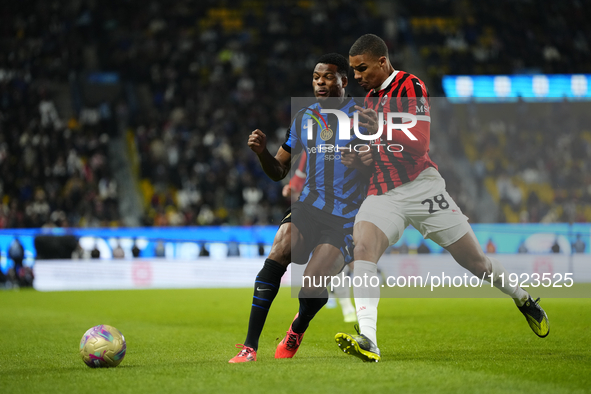 Denzel Dumfries right-back of Internazionale and Netherlands and Malick Thiaw centre-back of AC Milan and Germany compete for the ball durin...