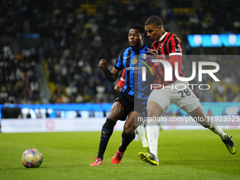 Denzel Dumfries right-back of Internazionale and Netherlands and Malick Thiaw centre-back of AC Milan and Germany compete for the ball durin...