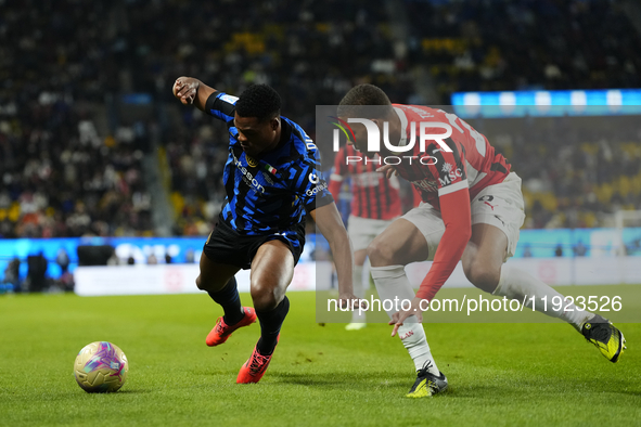 Denzel Dumfries right-back of Internazionale and Netherlands and Malick Thiaw centre-back of AC Milan and Germany compete for the ball durin...