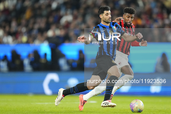 Mehdi Taremi centre-forward of Internazionale and Iran and Emerson Royal right-back of AC Milan and Brazil compete for the ball during the E...