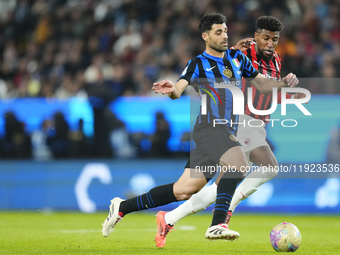 Mehdi Taremi centre-forward of Internazionale and Iran and Emerson Royal right-back of AC Milan and Brazil compete for the ball during the E...