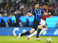 Mehdi Taremi centre-forward of Internazionale and Iran and Emerson Royal right-back of AC Milan and Brazil compete for the ball during the E...