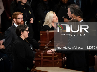 House floor staff close up the boxes containing electoral vote certificates following the conclusion of a oint session of Congress certifyin...