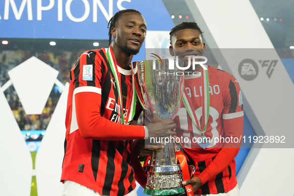 (D) Rafael Leao left winger of AC Milan and Portugal and (L) Tammy Abraham centre-forward of AC Milan and England celebrates with the trophy...