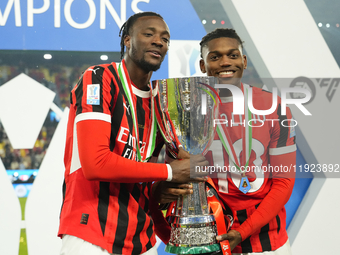 (D) Rafael Leao left winger of AC Milan and Portugal and (L) Tammy Abraham centre-forward of AC Milan and England celebrates with the trophy...