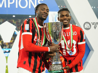 (D) Rafael Leao left winger of AC Milan and Portugal and (L) Tammy Abraham centre-forward of AC Milan and England celebrates with the trophy...