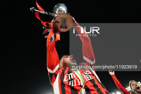 Theo Hernandez left-back of AC Milan and France lifts the trophy after winning with his team the EA SPORTS FC SUPERCUP 24/25 final match bet...