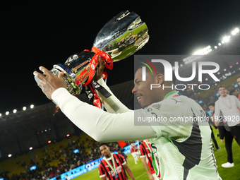 Mike Maignan goalkeeper of AC Milan and France celebrates with the trophy after winning the EA SPORTS FC SUPERCUP 24/25 final match between...