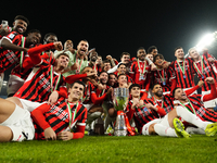 Milan players celebrate with the trophy after winning the EA SPORTS FC SUPERCUP 24/25 final match between FC Internazionale and AC Milan at...