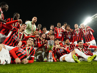 Milan players celebrate with the trophy after winning the EA SPORTS FC SUPERCUP 24/25 final match between FC Internazionale and AC Milan at...