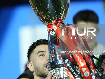 Theo Hernandez left-back of AC Milan and France lifts the trophy after winning with his team the EA SPORTS FC SUPERCUP 24/25 final match bet...